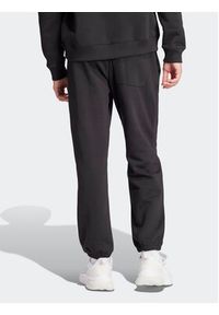 Adidas - adidas Spodnie dresowe ALL SZN Fleece Graphic IW1201 Czarny Regular Fit. Kolor: czarny. Materiał: bawełna