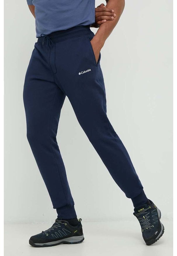 columbia - Columbia spodnie dresowe męskie kolor granatowy gładkie. Kolor: niebieski. Materiał: dresówka. Wzór: gładki