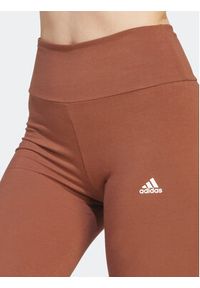 Adidas - adidas Legginsy ESSENTIALS HIGH-WAISTED LOGO IM2858 Brązowy Tight Fit. Kolor: brązowy. Materiał: bawełna