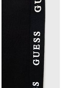 Guess legginsy dziecięce kolor czarny z nadrukiem. Kolor: czarny. Wzór: nadruk #3