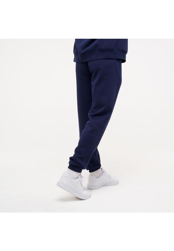 Spodnie dresowe męskie Puma Gym & Pilates. Kolor: niebieski. Materiał: dresówka. Sport: joga i pilates