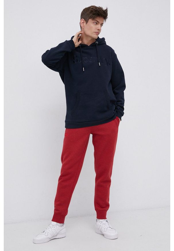 Superdry Spodnie męskie kolor czerwony gładkie. Kolor: czerwony. Materiał: dzianina. Wzór: gładki
