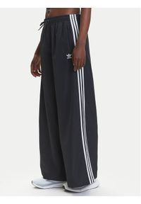 Adidas - adidas Spodnie dresowe adicolor Firebird JD3390 Czarny Loose Fit. Kolor: czarny. Materiał: syntetyk