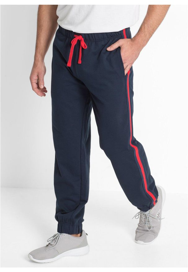 bonprix - Spodnie sportowe z kontrastowymi elementami. Kolor: niebieski. Materiał: dresówka. Styl: sportowy