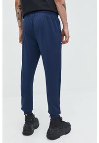 Ellesse spodnie dresowe męskie kolor granatowy gładkie. Kolor: niebieski. Materiał: dresówka. Wzór: gładki