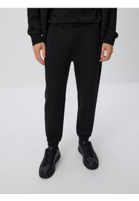Reserved - Spodnie dresowe slim fit - czarny. Kolor: czarny. Materiał: dresówka
