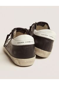 GOLDEN GOOSE - Czarne sneakersy ze skóry Superstar. Kolor: czarny. Materiał: skóra. Wzór: nadruk, aplikacja