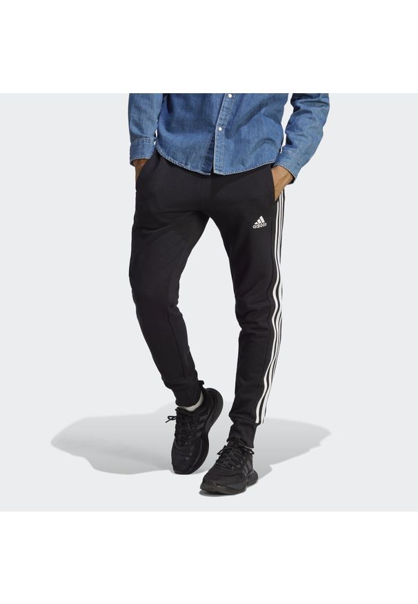 Adidas - Essentials French Terry Tapered Cuff 3-Stripes Pants. Kolor: biały, wielokolorowy, czarny. Materiał: dresówka