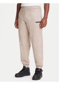 Guess Spodnie dresowe Z5YB03 KCJY2 Beżowy Regular Fit. Kolor: beżowy. Materiał: bawełna