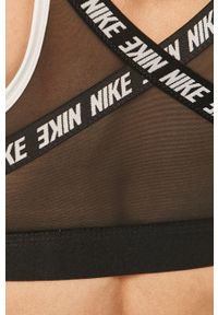 Nike - Biustonosz sportowy. Kolor: biały. Materiał: tkanina, włókno, skóra. Rodzaj stanika: wyciągane miseczki, odpinane ramiączka. Technologia: Dri-Fit (Nike). Wzór: nadruk #5