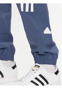 Adidas - adidas Spodnie dresowe Future Icons 3-Stripes IR9239 Niebieski Slim Fit. Kolor: niebieski. Materiał: syntetyk