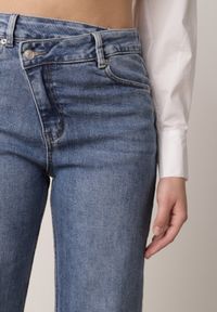 Born2be - Niebieskie Jeansy Bawełniane z Asymetrycznym Zapięciem i Wywiniętymi Nogawkami Ellenesta. Okazja: na co dzień, na spacer. Kolor: niebieski. Styl: casual, elegancki #6