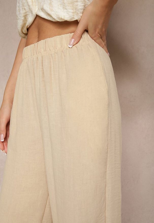 Renee - Beżowe Spodnie Palazzo o Szerokim Kroju High Waist Ollevia. Okazja: na co dzień, na spotkanie biznesowe. Stan: podwyższony. Kolor: beżowy. Materiał: jedwab. Wzór: aplikacja. Styl: biznesowy, elegancki, casual