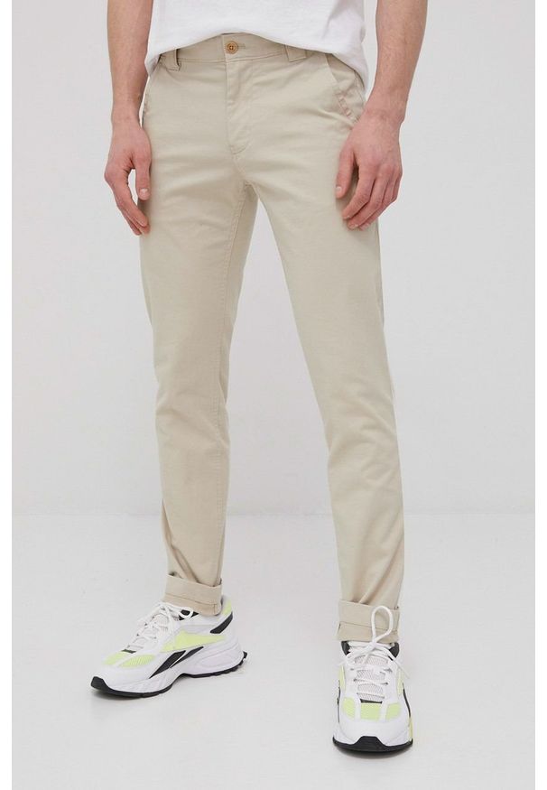 Tommy Jeans Spodnie męskie kolor beżowy w fasonie chinos. Kolor: beżowy. Materiał: tkanina, bawełna, materiał. Wzór: gładki