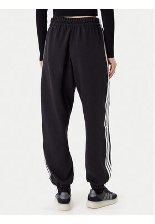 Adidas - adidas Spodnie dresowe Essentials 3-Stripes Fleece JE1276 Czarny Loose Fit. Kolor: czarny. Materiał: bawełna