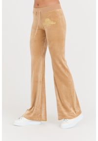 Juicy Couture - JUICY COUTURE Beżowe spodnie Arched Metallic Layla. Kolor: beżowy