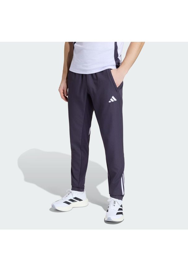 Adidas - Spodnie reprezentacyjne Manchester United Tiro 25 Competition. Kolor: fioletowy, wielokolorowy, czarny. Materiał: dresówka. Sport: piłka nożna