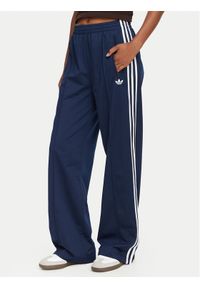 Adidas - adidas Spodnie dresowe Firebird KV5403 Niebieski Loose Fit. Kolor: niebieski. Materiał: syntetyk #1