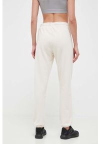 DKNY - Dkny spodnie dresowe kolor beżowy gładkie. Kolor: beżowy. Materiał: dresówka. Wzór: gładki #4
