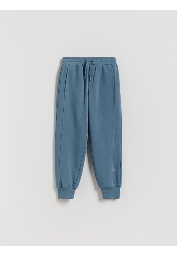 Reserved - Bawełniane joggery z meszkiem - niebieski. Kolor: niebieski. Materiał: bawełna