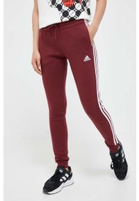 Adidas - adidas spodnie dresowe kolor bordowy z aplikacją. Kolor: czerwony. Materiał: dresówka. Wzór: aplikacja #1