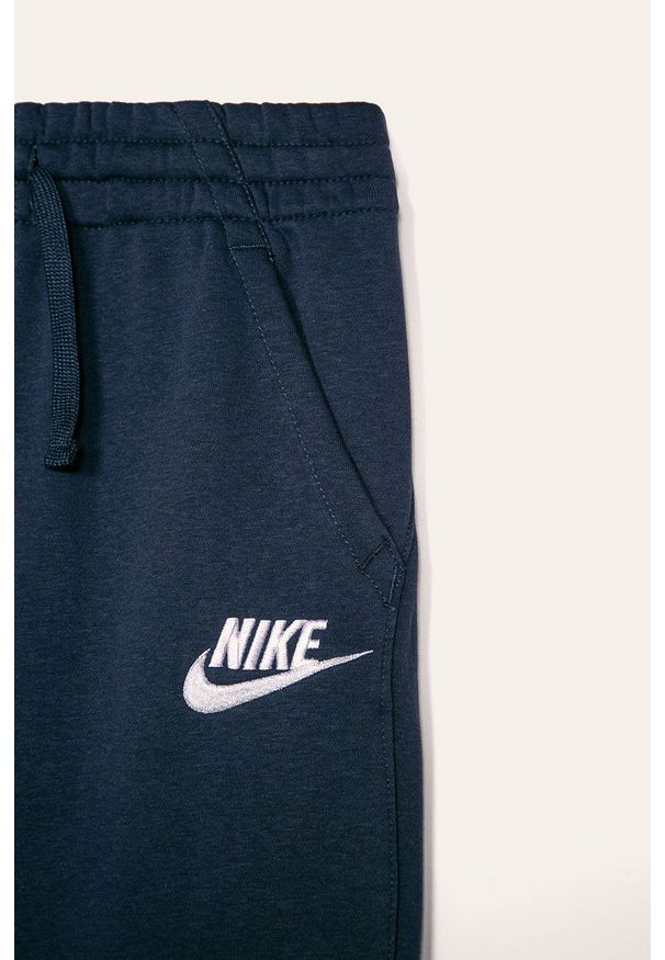 Nike Kids - Spodnie dziecięce 122-170 cm. Kolor: niebieski. Materiał: materiał, dzianina. Wzór: gładki