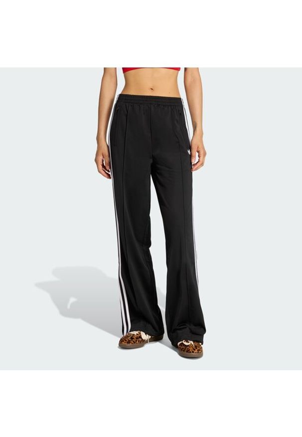 Adidas - adidas Spodnie dresowe Firebird KD7976 Czarny Loose Fit. Kolor: czarny. Materiał: syntetyk