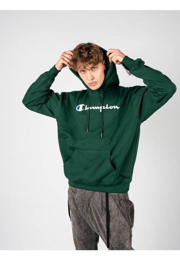 Champion Bluza "Hoodie" | HBGF89HY07718 | Mężczyzna | Zielony. Okazja: na co dzień. Typ kołnierza: kaptur. Kolor: zielony. Materiał: poliester, bawełna. Wzór: aplikacja. Styl: casual