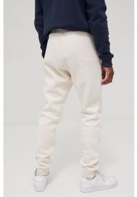 adidas Originals spodnie Adicolor męskie kolor beżowy gładkie. Kolor: beżowy. Materiał: dzianina, materiał, bawełna. Wzór: gładki