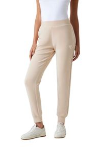 Guess - GUESS Spodnie damskie dresowe w kolorze taupe Olympe. Kolor: beżowy. Materiał: dresówka