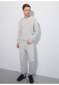 Ochnik - Kremowe spodnie dresowe męskie. Kolor: beżowy. Materiał: bawełna. Wzór: nadruk #4
