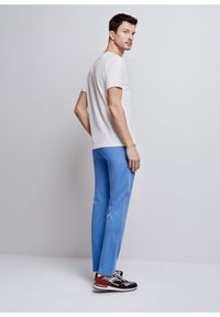 Ochnik - Niebieskie spodnie męskie. Kolor: niebieski. Materiał: bawełna