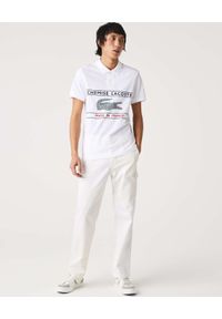 Lacoste - LACOSTE - Biała koszulka polo Made In France. Typ kołnierza: polo. Kolor: biały. Materiał: bawełna. Wzór: aplikacja, nadruk. Styl: klasyczny