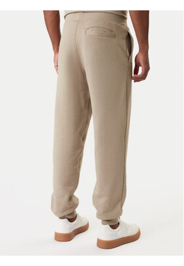 Guess Spodnie dresowe Z6RB12 KAIJ1 Beżowy Regular Fit. Kolor: beżowy. Materiał: bawełna