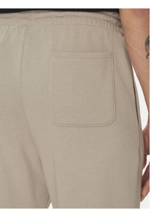 New Balance Spodnie dresowe Essentials MP41519 Beżowy Relaxed Fit. Kolor: beżowy. Materiał: bawełna