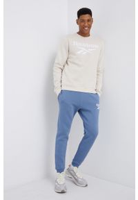 Reebok - Spodnie. Kolor: niebieski. Materiał: włókno. Wzór: nadruk #2