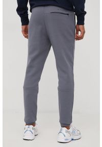 New Balance spodnie dresowe męskie kolor szary gładkie. Kolor: szary. Materiał: dresówka. Wzór: gładki