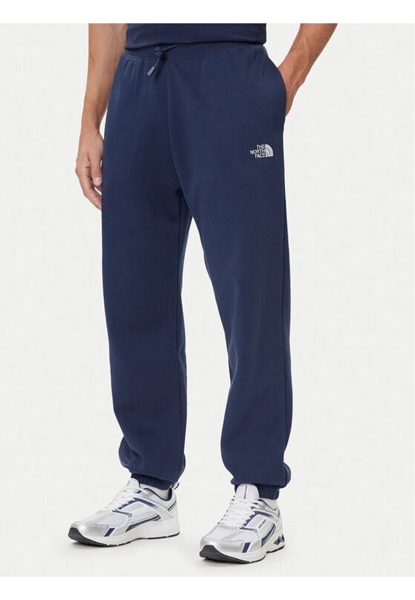 The North Face Spodnie dresowe Essential NF0A8C1F Granatowy Relaxed Fit. Kolor: niebieski. Materiał: syntetyk, bawełna