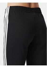 Adidas - adidas Spodnie dresowe 3S Flared KQ6424 Czarny Regular Fit. Kolor: czarny. Materiał: bawełna #4