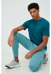 Guess spodnie dresowe kolor niebieski melanżowe. Kolor: niebieski. Materiał: dresówka. Wzór: melanż #3