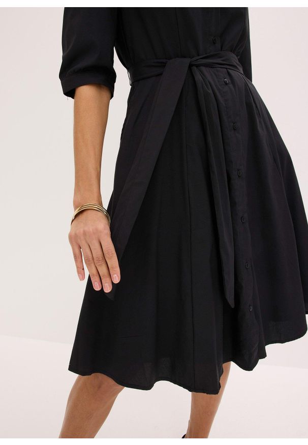 bonprix - Szmizjerka z koronką i wiązanym paskiem. Kolor: czarny. Materiał: koronka. Wzór: koronka. Typ sukienki: szmizjerki, koszulowe. Styl: elegancki