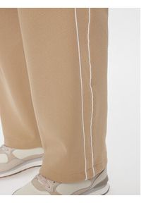 Puma Spodnie dresowe T7 624212 Beżowy Relaxed Fit. Kolor: beżowy. Materiał: bawełna