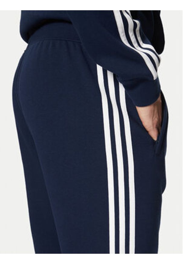 Adidas - adidas Spodnie dresowe adicolor 3-Stripes IM9319 Granatowy Slim Fit. Kolor: niebieski. Materiał: bawełna, syntetyk