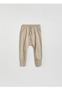 Reserved - Dresowe spodnie - beżowy. Kolor: beżowy. Materiał: dresówka