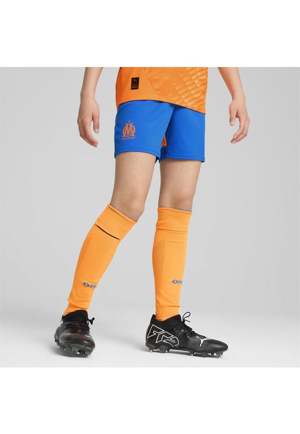 Puma - Młodzieżowe szorty Olympique Marsylia 24/25 PUMA Racing Blue Fluro Orange Pes. Kolor: pomarańczowy, niebieski, wielokolorowy, żółty. Sport: piłka nożna