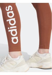 Adidas - adidas Legginsy ESSENTIALS HIGH-WAISTED LOGO IM2858 Brązowy Tight Fit. Kolor: brązowy. Materiał: bawełna