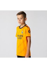 Koszulka piłkarska dla dzieci Real Madrid Away 24/25. Kolor: pomarańczowy. Sport: piłka nożna