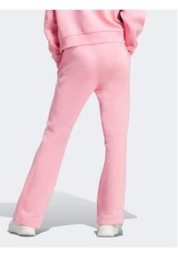 Adidas - adidas Spodnie dresowe ALL SZN Fleece Graphics Joggers IC8718 Różowy Regular Fit. Kolor: różowy. Materiał: bawełna