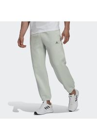 Adidas - Bawełniany kombinezon do joggingu adidas Essentials Colorblock. Kolor: zielony. Materiał: bawełna. Sport: bieganie