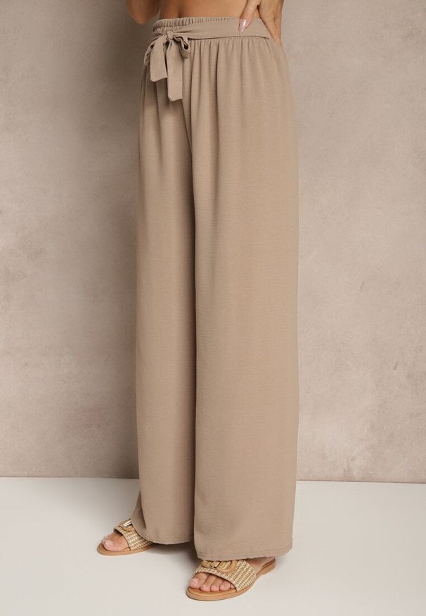 Renee - Ciemnobeżowe Szerokie Spodnie High Waist z Wiązaniem w Talii Reivaritta. Okazja: na spotkanie biznesowe, do pracy, na co dzień. Stan: podwyższony. Kolor: beżowy. Styl: elegancki, biznesowy, casual
